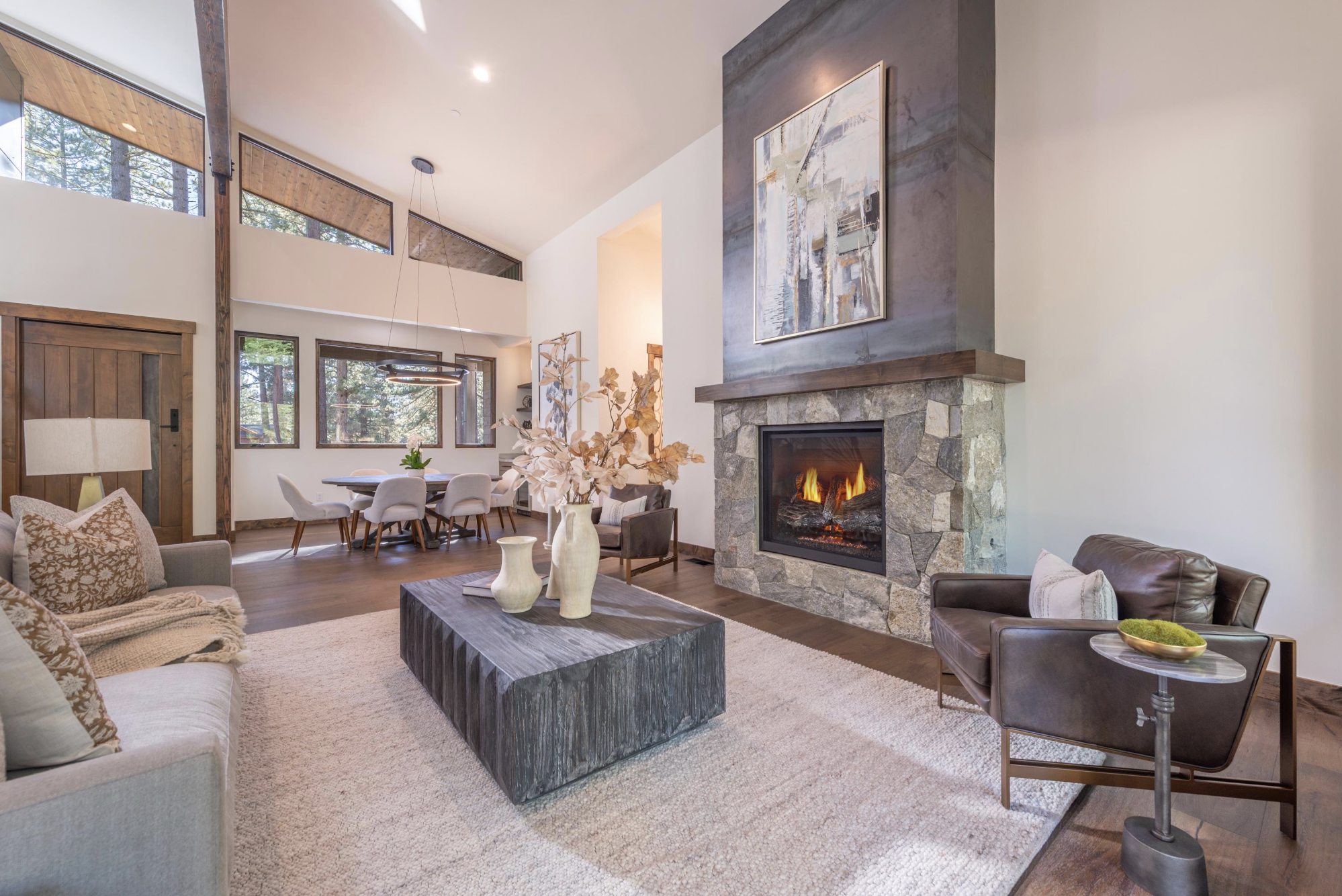 Great room with stone fireplace and open dining area